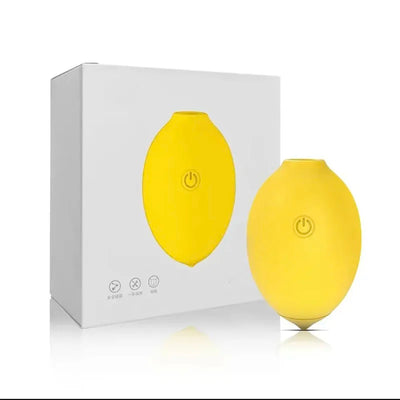 Lemon clitoral suction toy placed next to its clean white retail packaging box